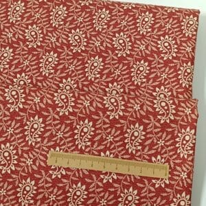 Tela roja con dibujos crema